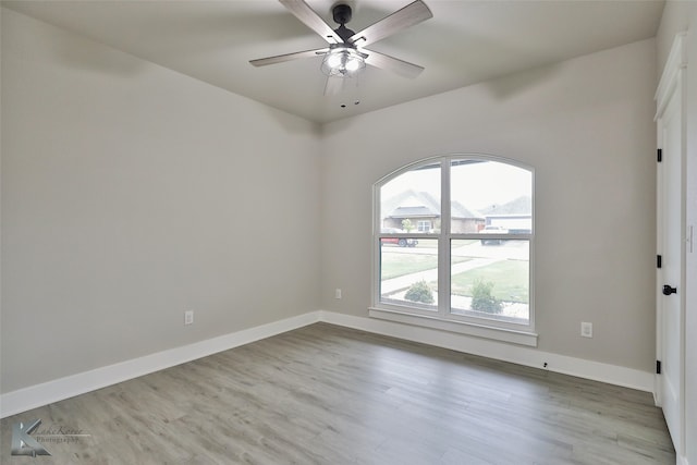 empty room with ceiling fan and hardwood / wood-style floors