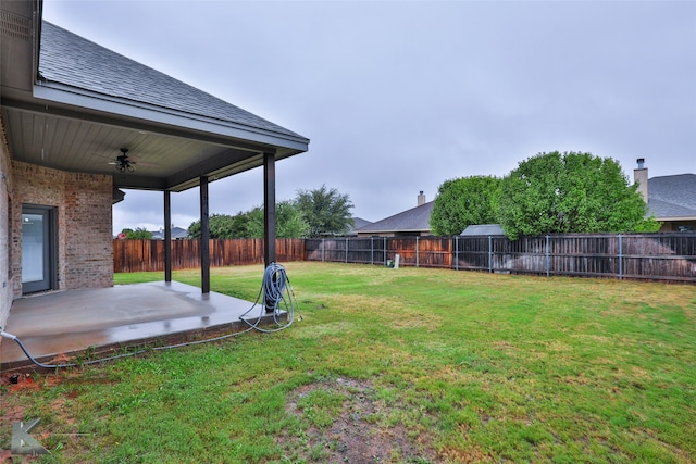 view of yard featuring ceiling fan and a patio area