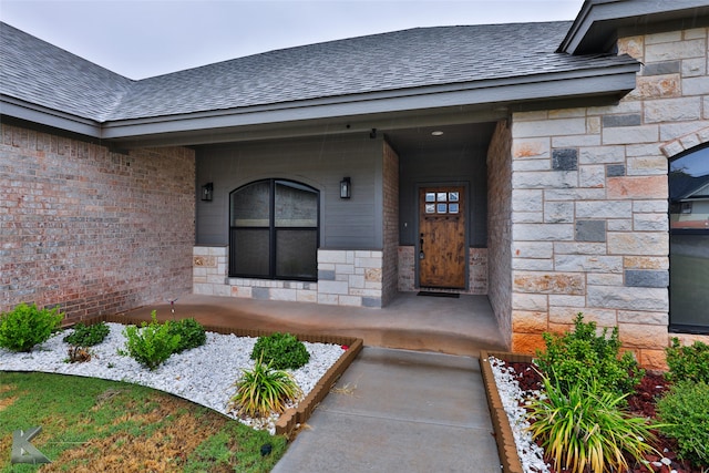 view of exterior entry featuring a porch