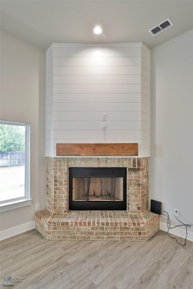 details featuring wood-type flooring and a brick fireplace