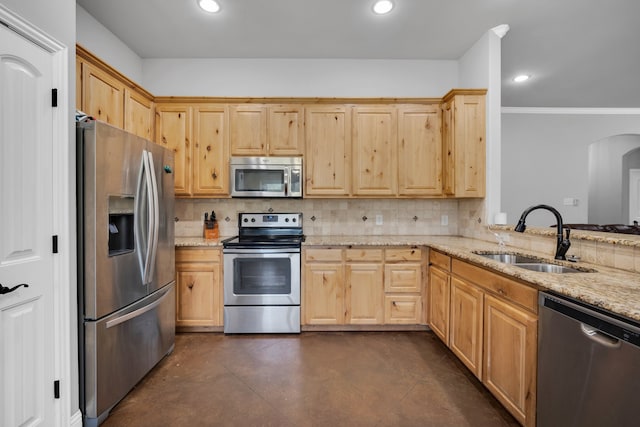 kitchen with crown molding, stainless steel appliances, sink, decorative backsplash, and light stone counters