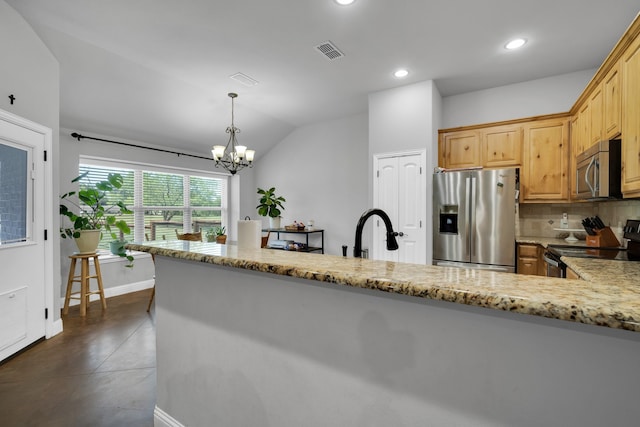 kitchen with vaulted ceiling, decorative light fixtures, appliances with stainless steel finishes, light stone countertops, and a chandelier