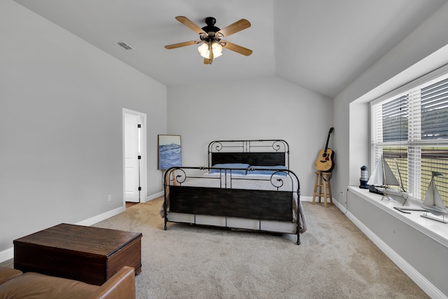 bedroom featuring ceiling fan, light carpet, and vaulted ceiling