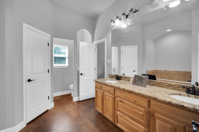 bathroom with vanity, toilet, and tile patterned floors