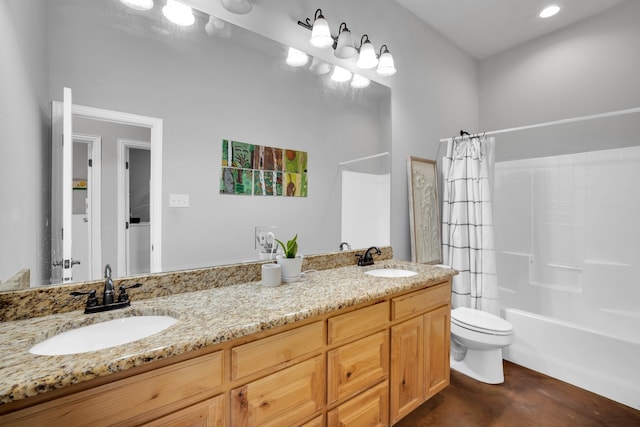 full bathroom featuring shower / bath combo with shower curtain, toilet, and vanity