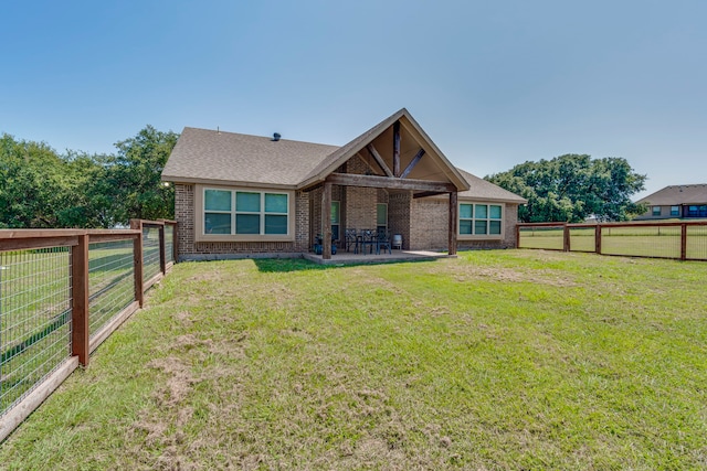 view of front of property with a patio area and a front yard