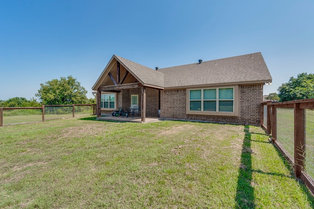 back of house featuring a yard and a patio