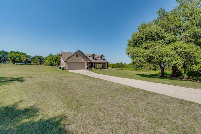 view of front of home with a garage and a front lawn