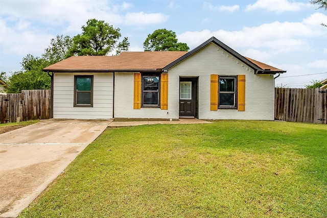 ranch-style home with a front lawn