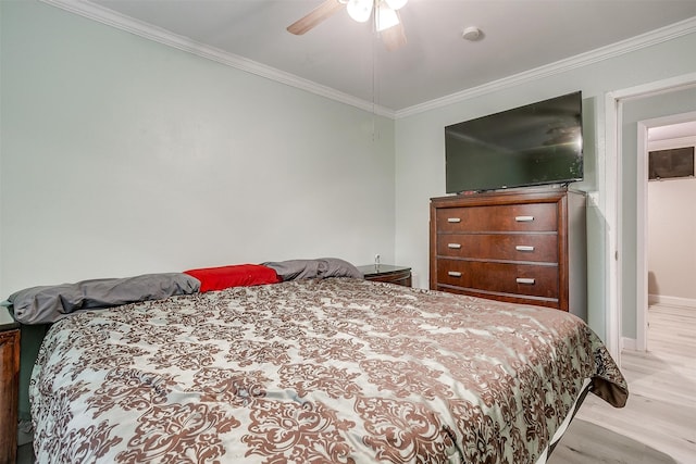 bedroom with light hardwood / wood-style flooring, ceiling fan, and ornamental molding