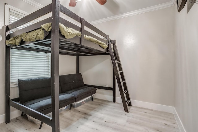 bedroom with crown molding, ceiling fan, and wood-type flooring