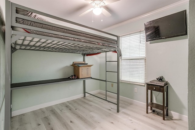 unfurnished bedroom featuring ceiling fan, light hardwood / wood-style flooring, and ornamental molding