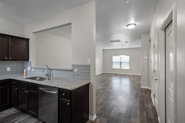 kitchen featuring tasteful backsplash, sink, dark hardwood / wood-style flooring, light stone countertops, and stainless steel dishwasher