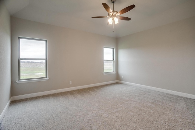 carpeted empty room featuring ceiling fan