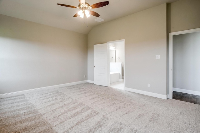 unfurnished bedroom with connected bathroom, carpet floors, ceiling fan, and vaulted ceiling