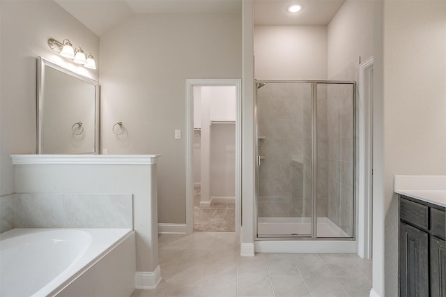 bathroom with lofted ceiling, tile patterned flooring, separate shower and tub, and vanity