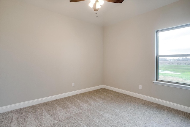 carpeted empty room featuring ceiling fan