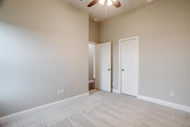 unfurnished bedroom featuring ceiling fan and light carpet