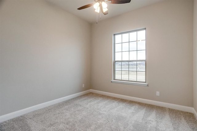 carpeted spare room with ceiling fan