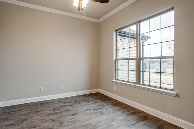 empty room featuring ceiling fan, hardwood / wood-style flooring, ornamental molding, and a healthy amount of sunlight