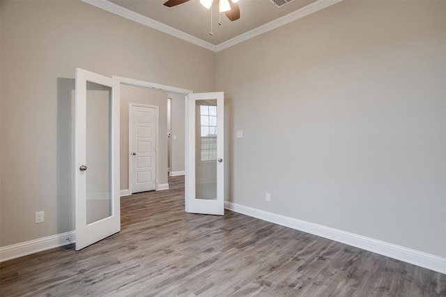 unfurnished bedroom featuring ornamental molding, ceiling fan, french doors, and wood-type flooring