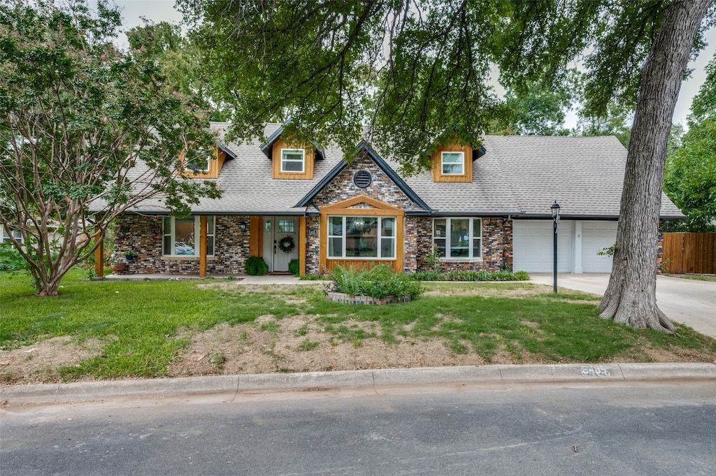 view of front of house with a garage and a front lawn