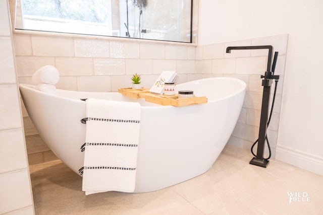 bathroom featuring a bathing tub, tile walls, and tile patterned floors