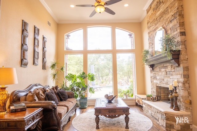 sunroom / solarium featuring ceiling fan and a fireplace