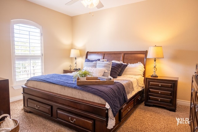 bedroom featuring ceiling fan and light carpet