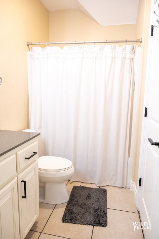 bathroom featuring vanity, toilet, and tile patterned flooring