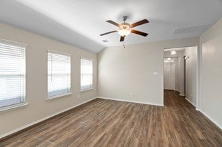 unfurnished room featuring vaulted ceiling, ceiling fan, and dark hardwood / wood-style flooring