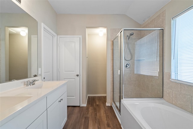 bathroom featuring a wealth of natural light, lofted ceiling, hardwood / wood-style floors, and independent shower and bath