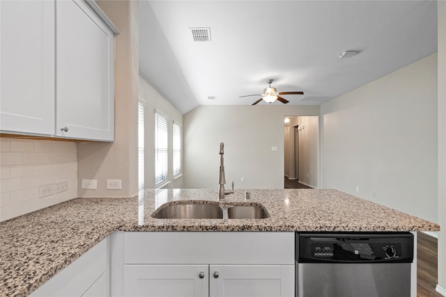 kitchen featuring dark wood-type flooring, sink, light stone countertops, stainless steel dishwasher, and white cabinets