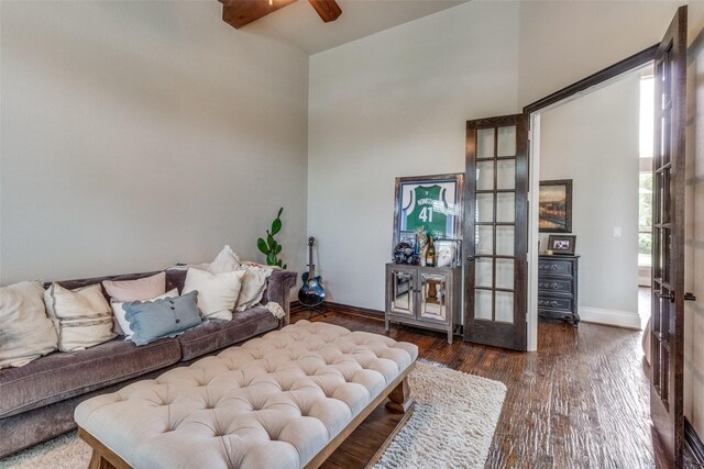 interior space featuring dark wood-type flooring, ceiling fan, and a towering ceiling