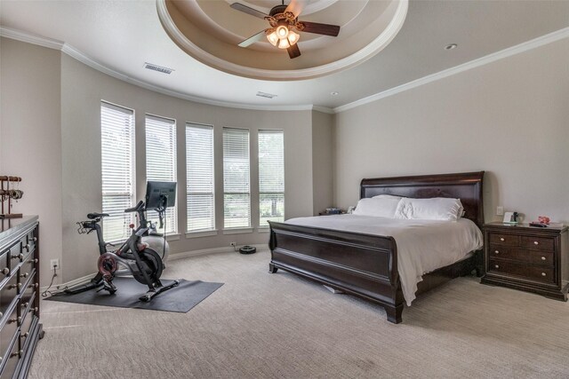 bedroom featuring ceiling fan, a raised ceiling, light carpet, and ornamental molding