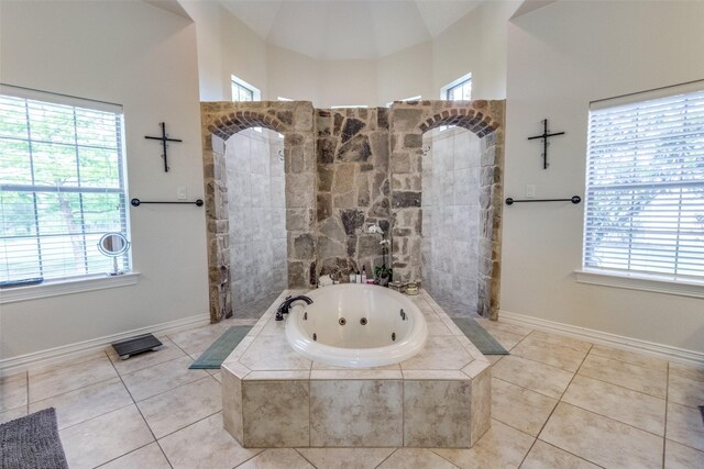 bathroom featuring high vaulted ceiling, separate shower and tub, and tile patterned flooring