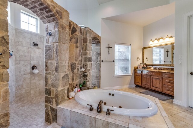 bathroom with shower with separate bathtub and vanity