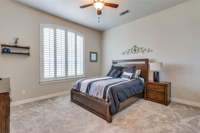 bedroom with light carpet and ceiling fan