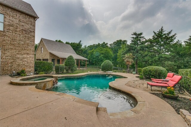 view of pool with a patio area and an in ground hot tub