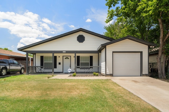 ranch-style house featuring a garage, a porch, and a front yard