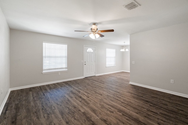 interior space featuring dark hardwood / wood-style flooring and ceiling fan with notable chandelier