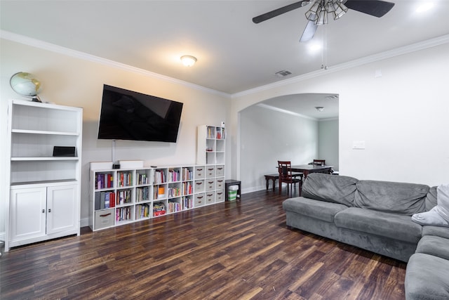 living room featuring ornamental molding, dark wood-type flooring, and ceiling fan