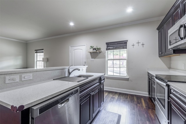 kitchen featuring appliances with stainless steel finishes, dark hardwood / wood-style flooring, a wealth of natural light, and sink