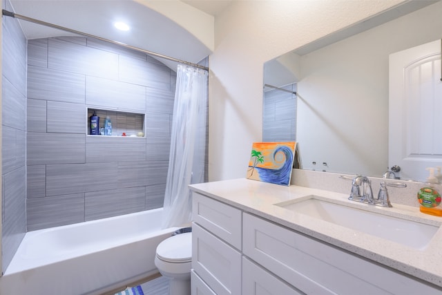 full bathroom featuring vanity, toilet, and shower / bath combination with curtain