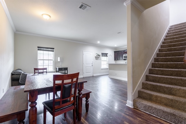 dining room with dark hardwood / wood-style floors and crown molding