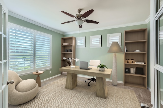 office space featuring ceiling fan, crown molding, and light carpet