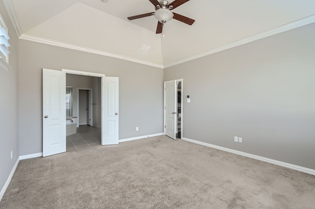 unfurnished bedroom featuring ceiling fan, light colored carpet, ensuite bath, and ornamental molding