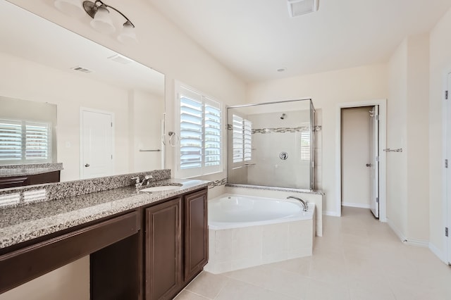 bathroom featuring vanity, separate shower and tub, tile patterned floors, and a wealth of natural light