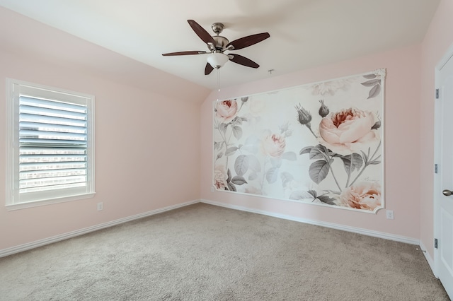 carpeted spare room featuring ceiling fan