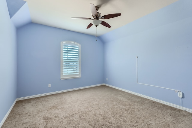 spare room with lofted ceiling, ceiling fan, and carpet floors